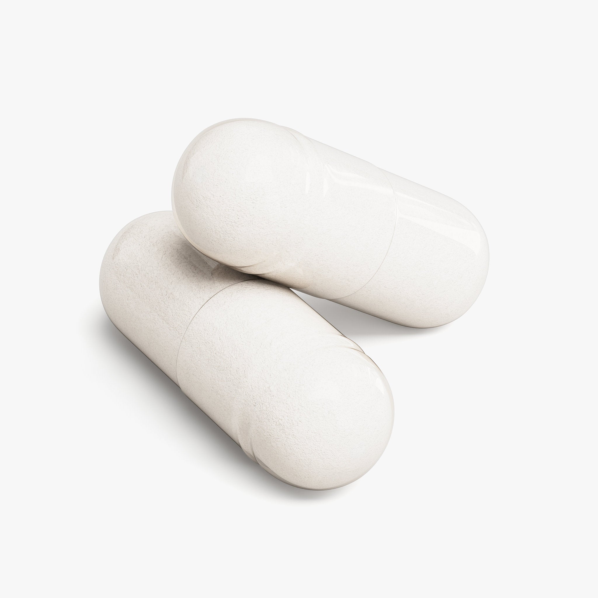 Two white pills on a light gray background