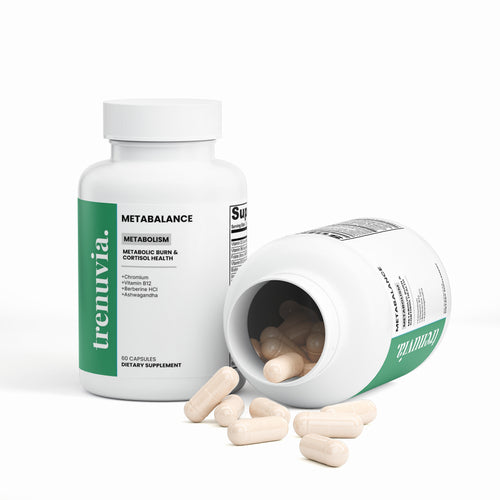 A white bottle of trenuvia Metabalance dietary supplement with a green label, shown alongside an overturned bottle spilling beige capsules on a clean white background.